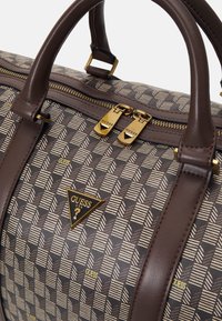 Brown patterned handbag made of synthetic material, featuring gold hardware, dual zippers, and a triangular logo accent.