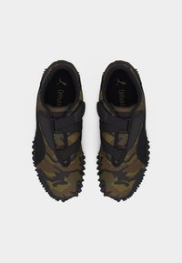 Pair of camo-patterned sneakers with black straps, rugged soles, and Ortholite insoles, shown from a top-down view.