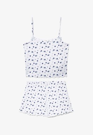 Set pigiama con canotta bianca a coste e pantaloncini, con pois blu e grigi e piccoli dettagli a fiocco sulle spalline.