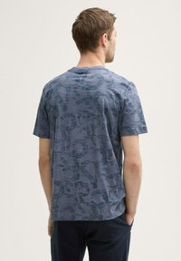 Short-sleeve navy blue T-shirt featuring a textured pattern, crew neckline, and a relaxed fit, viewed from the back.