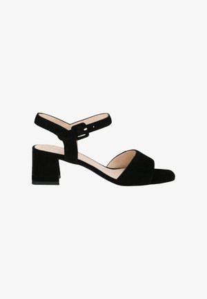 Black suede heeled sandal with an open toe, ankle straps, and a square block heel. The design features smooth texture and minimalistic accents.