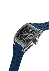 Orologio quadrato in argento con cinturino in gomma blu, quadrante nero texturizzato, accenti blu e cassa in acciaio inossidabile. Presenta più sottodial.