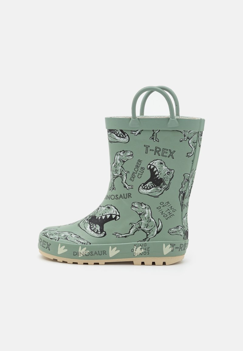 Botte de pluie verte pour enfant ornée d'illustrations de dinosaures, d'empreintes de dinosaures, et de textes comme "T-REX" et "Roi des Dinos", avec deux poignées.