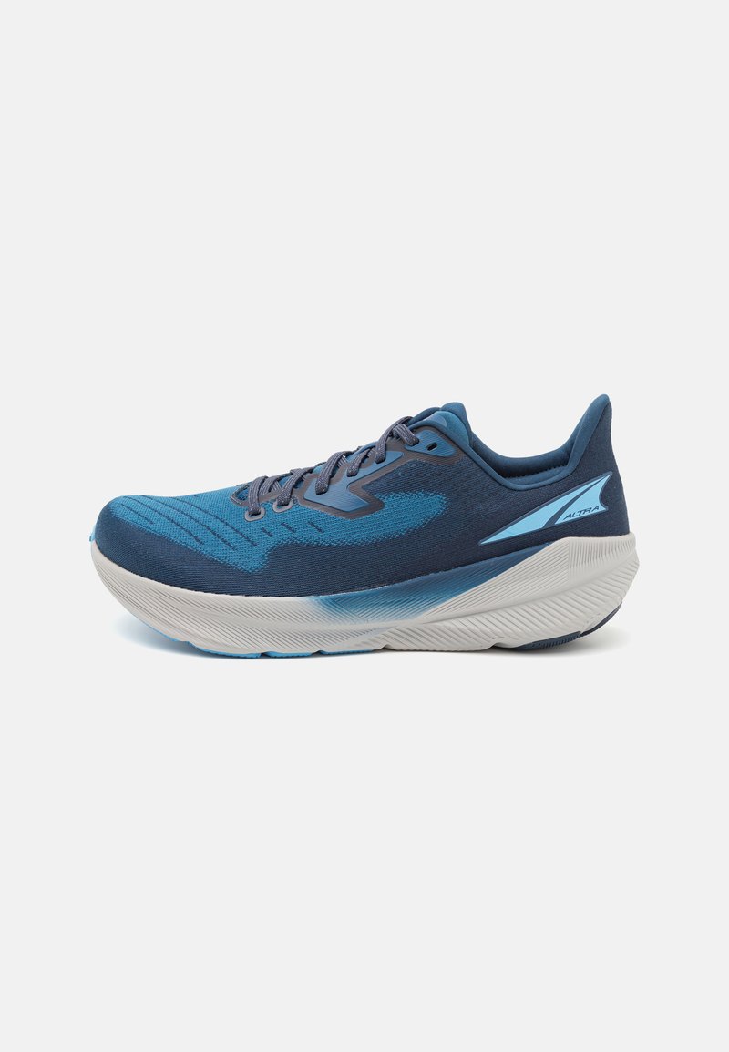 Blue athletic shoe with a textured upper, featuring a gradient design and a cushioned white sole. Includes gray laces and logo accents.