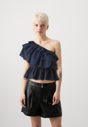 Navy one-shoulder top with ruffled layers and a gathered waist, paired with black faux leather shorts featuring a double-button closure.