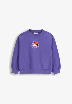 Fioletowa bluza z długim rękawem, okrągłym dekoltem i grafiką na przodzie przedstawiającą twarz Minnie Mouse z pomarańczową kokardą na różowym tle w kształcie rozbłysku gwiazdy.