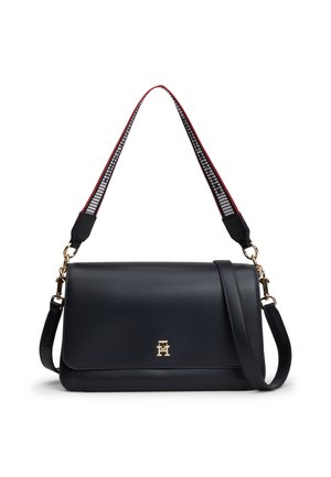 Black leather shoulder bag with gold-tone clasp, two adjustable straps including a patterned fabric one with red edges.