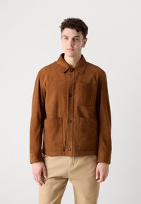 Brown suede jacket with a collar, front button closure, and two large pockets. Features a smooth texture and tailored fit.