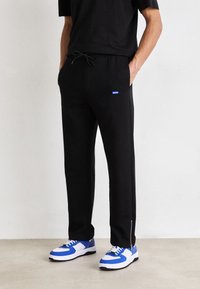 HUGO NANETTI - Pantalones deportivos - black