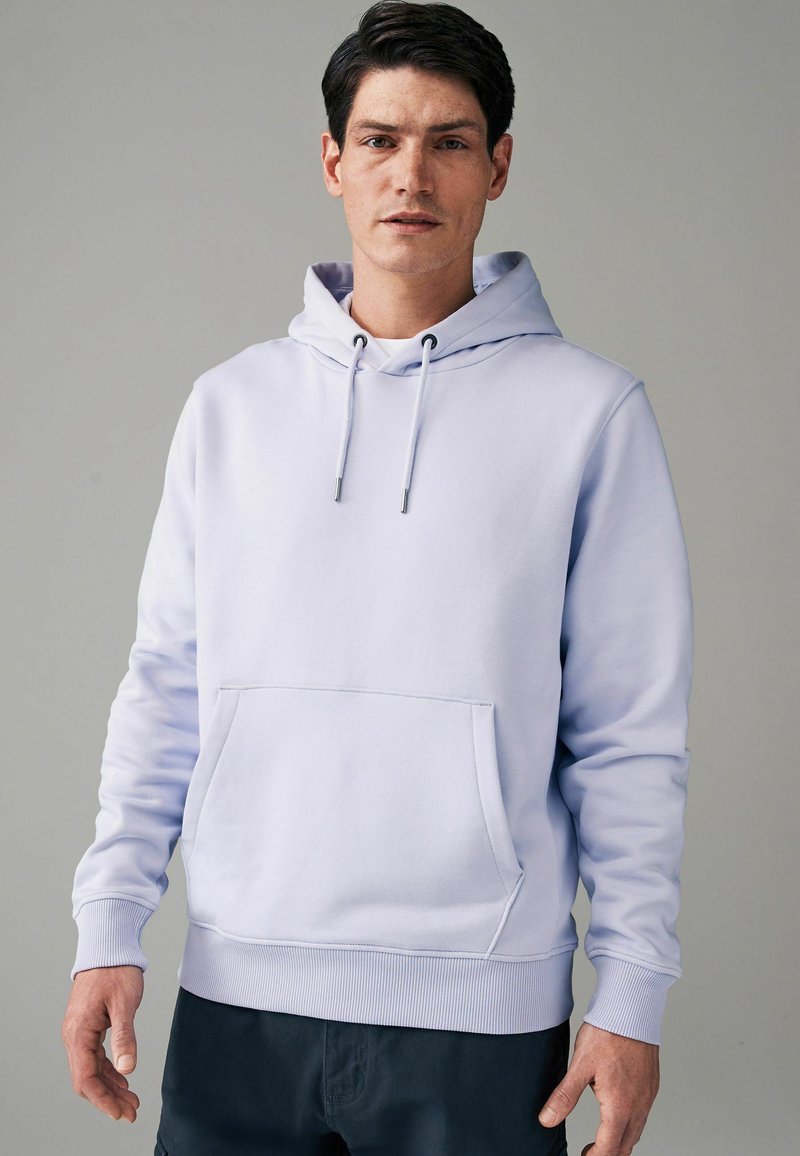 Helle lila Kapuzenpulli aus weichem Material mit einer Fronttasche, verstellbaren Kordeln und gerippten Bündchen und Saum. Glatte Textur.