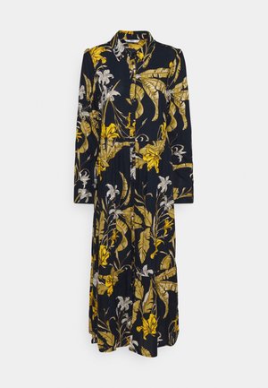 Květinové šaty v námořnické modři s žlutými a bílými botanickými vzory, dlouhé rukávy, límec, zapínání na knoflíky a volný silueta. Měkká, texturovaná tkanina.