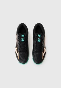 Black athletic shoes with mesh upper, bright orange accents, teal tongue, and green outsole. Features laces and padded collar for support.
