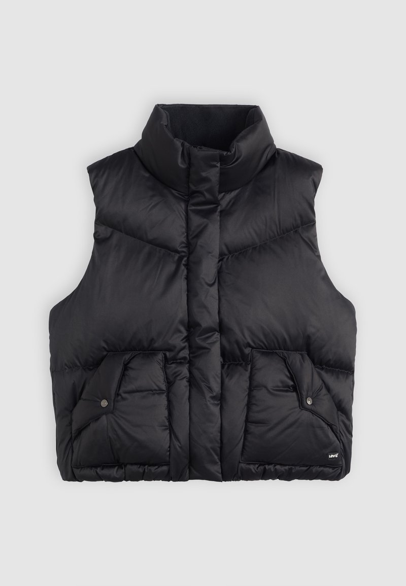 Gilet rembourré noir avec un col montant, comportant deux poches avant avec fermetures à pression et une texture matelassée. Le matériau semble doux et isolant.