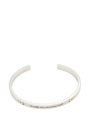 Silver open cuff bracelet with small green leaf designs and the inscription "She walks where stars forget to fall" on the front.