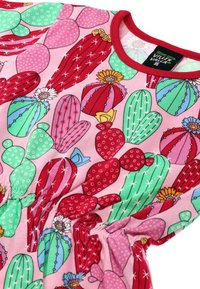 Pink cotton dress with a cactus pattern, featuring green and red accents. It has a gathered waist and a red neckline. The patterns include flowers and dots.
