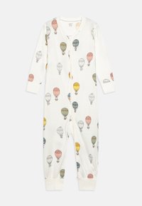 Pyjamas blancs avec un motif de montgolfières colorées. Manches longues, tissu doux, et fermeture éclair à l'avant. Poignets élastiques.