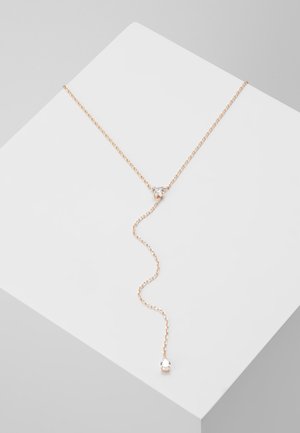 Fijn ketting van roségoud met twee heldere edelsteenaccenten, tentoongesteld op een witte geometrische blokachtergrond.