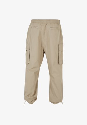 Beežid tööpüksid elastse vöökohaga, külgedel klapiga taskud, taga välimised taskud ja reguleeritavad nöörid äärtes.