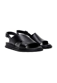 Sandali in pelle nera con design aperto sulla punta, caratterizzati da fasce incrociate, fibbia alla caviglia e suola testurizzata per trazione e comfort.