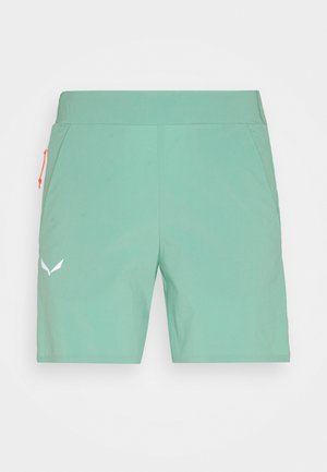 Hellgrüne Shorts mittlerer Länge mit elastischem Bund, Seitentaschen und kleinem weißen Logo am linken Bein.