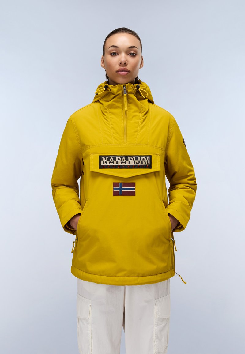 Gelbe wasserfeste Jacke mit hohem Kragen, Reißverschluss vorne und großer Brusttasche. Enthält ein Patch mit der norwegischen Flagge und ein Logo.