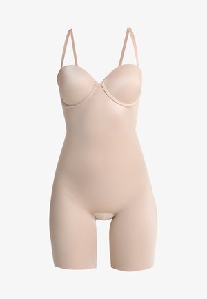 Beige bodysuit with molded cups, thin adjustable straps, a smooth texture, and a mid-thigh length, featuring a seamless design.
