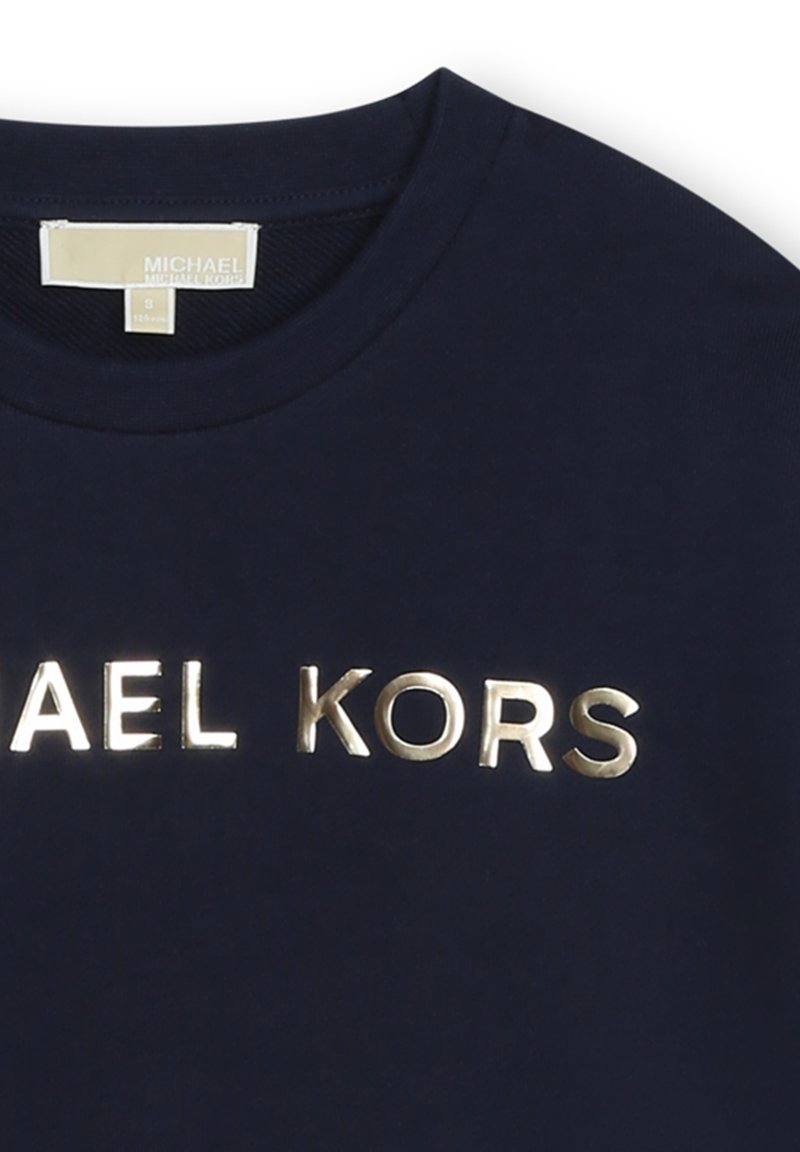 T-shirt in cotone blu navy con scollatura rotonda e logo "MICHAEL KORS" in oro metallico sulla parte anteriore. Tessuto morbido, vestibilità standard.