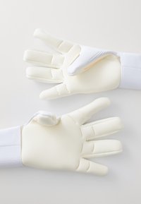 White goalie gloves with textured latex palms, padded fingers, and a breathable mesh back. The wrist features a secure closure.