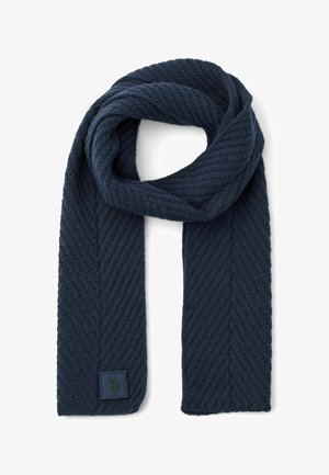 Navy blue textured scarf with a ribbed design, featuring a rectangular logo patch in one corner. Made from soft, woven material.
