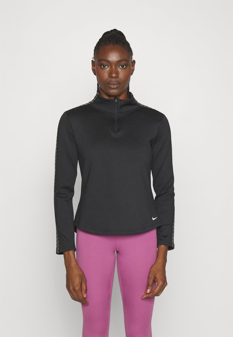 Zwarte rits-up langmouwtop met een hoge kraag en zijpatronen, gecombineerd met roze leggings. Zachte stof met een aansluitend ontwerp.