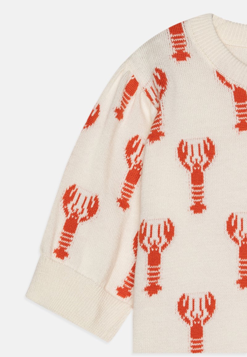 Strickpullover in Creme mit einem Hummer-Muster in leuchtendem Orange. Verfügt über gerippte Bündchen und einen klassischen Rundhalsausschnitt.