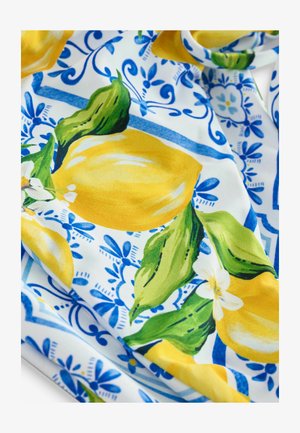 Colorful fabric featuring large yellow lemons and green leaves on a white background, accented with blue floral and geometric patterns.