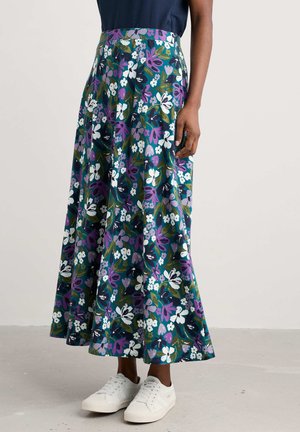 Floral maxi skirt in dark green with purple, white, and blue flowers. Made of lightweight fabric; features a fitted waistband and flared silhouette.