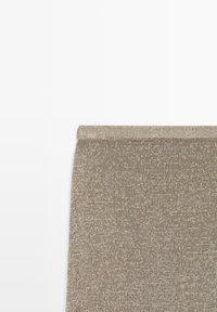 Panneau en tissu tricoté beige avec un bord roulé en haut, affiché sur fond blanc.