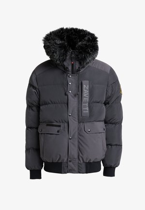 Padded black jacket with a faux fur hood, featuring a zip closure, two front pockets, and a logo patch on the chest. Textured fabric.