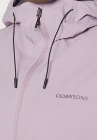 Light purple waterproof jacket with a zip closure, adjustable drawstring hood, and black accent hardware. Features the logo "DIDRIKSONS."