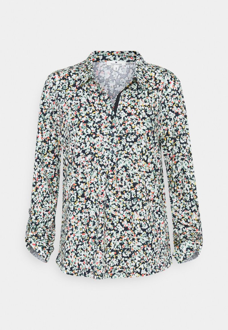 Blumenhemd mit Knopfleiste und Kragen, mit einem dunklen Grundton und weißen, rosa und grünen Blumenmustern. Lange Ärmel, leichtes Material.