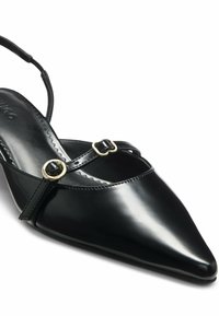 Black patent leather slingback shoe with a pointed toe, featuring a slender strap with a gold buckle accent. Smooth, glossy finish.