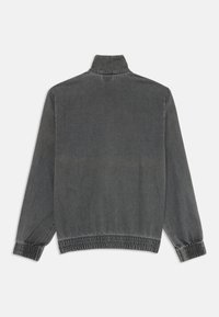 Gray soft fabric jacket with a high collar, elasticized cuffs, and a gathered hem. Features a plain design with minimal visible stitching.