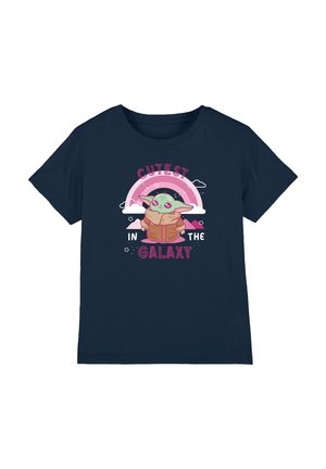 Marineblaue T-Shirt mit einer grünen Alien-Figur in einem braunen Mantel unter einem rosa Regenbogen und dem Text "Niedlichste in der Galaxie."