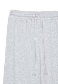 Hellegraue Jogginghose aus weichem Material mit elastischem Bund, verstellbarem Kordelzug und Seitentaschen. Subtle melierte Textur.