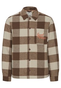 Brown and cream checkered flannel shirt with a button front, collar, and a left chest pocket featuring "Good Vibes" in orange text.