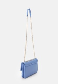 Light blue faux leather crossbody bag with a gold chain strap, featuring a quilted texture and a folded design.