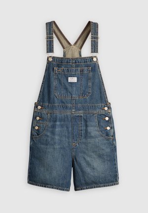 Denim overalls med justerbare stropper, forlommer, fire knapper på siderne og opsmøgede shorts. Medium blå vask med let falming.