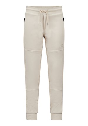 Beige sweatpants van zacht materiaal, met een elastische tailleband met trekkoord, zijzakken en geribde manchetten. Flat seam-details zichtbaar.