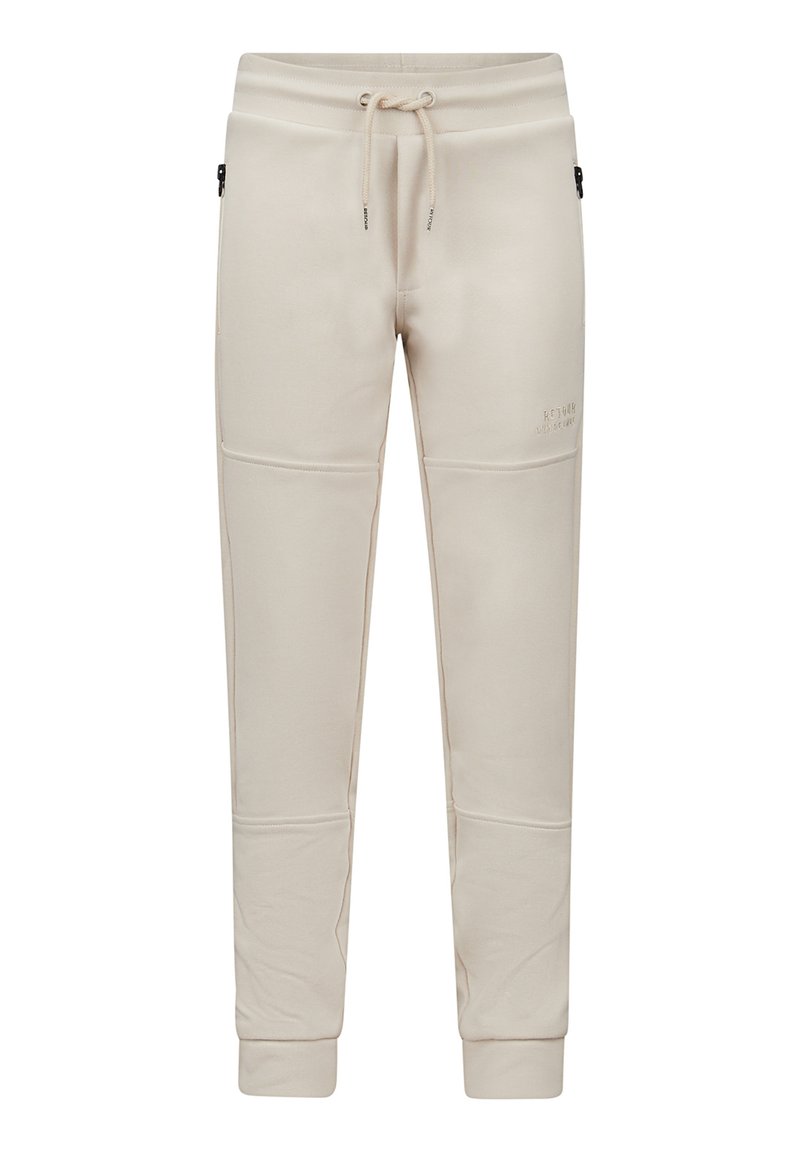 Beige sweatpants van zacht materiaal, met een elastische tailleband met trekkoord, zijzakken en geribde manchetten. Flat seam-details zichtbaar.