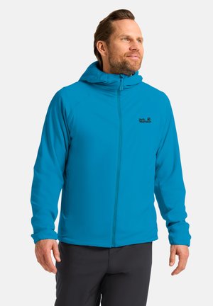 La veste zippée bleue est dotée d'une capuche, d'un tissu léger et d'un logo sur la poitrine gauche. Les poignets sont ajustés et le design est épuré.