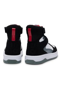 High-top sneakers featuring a black suede upper, white rubber sole, red accents, and embossed branding on the heel. Mesh details add texture.