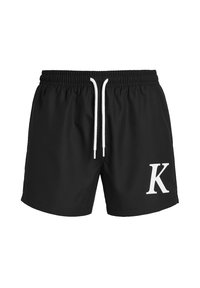 Bañadores negros con cinturilla elástica, cordón blanco y una gran letra 'K' blanca impresa en la parte delantera izquierda.
