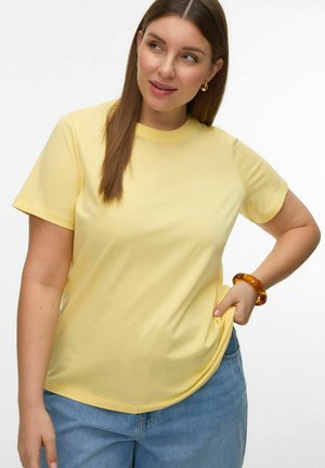 Short-sleeve yellow t-shirt made of soft fabric, featuring a round neckline, relaxed fit, and a smooth texture. Paired with blue denim jeans.